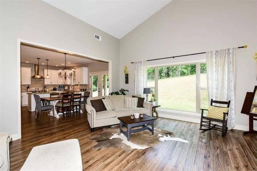 Spacious Living Area with Vaulted Ceiling and Large Window