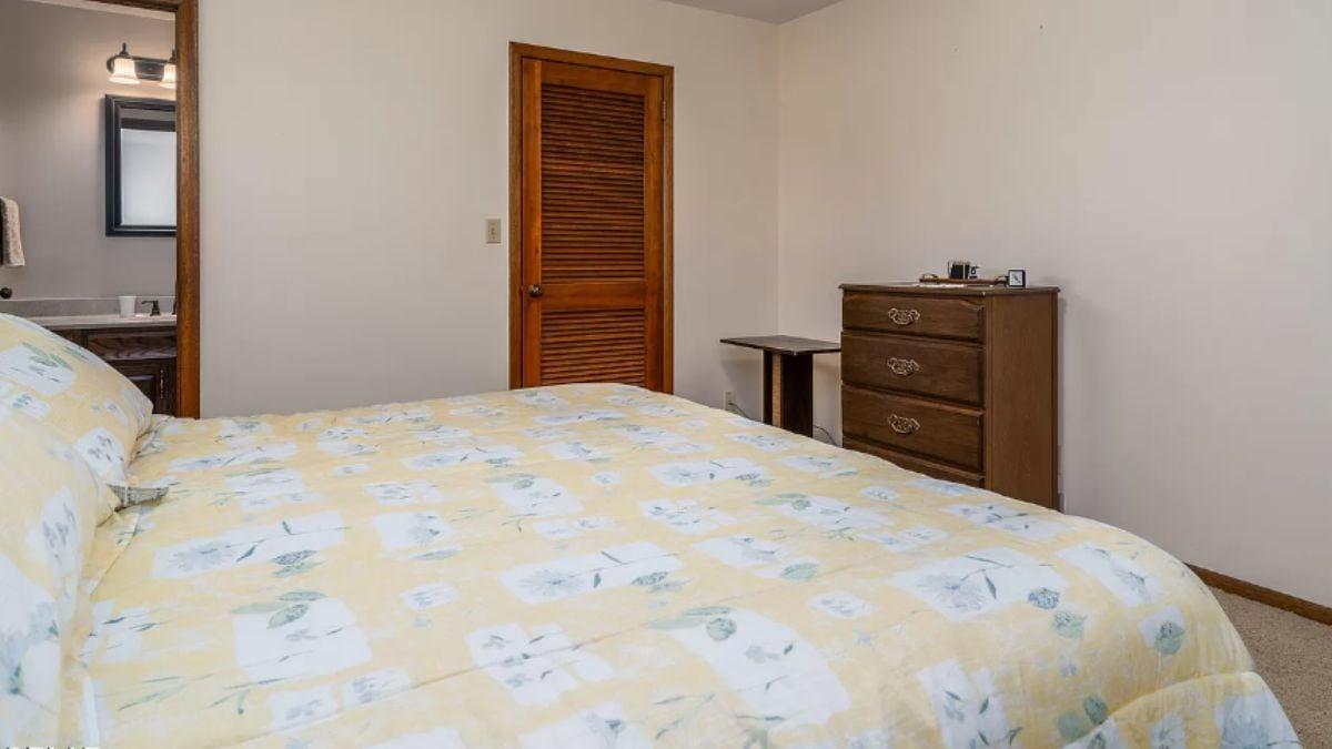 Cozy Bedroom with Vintage Charm and Louvered Closet Door