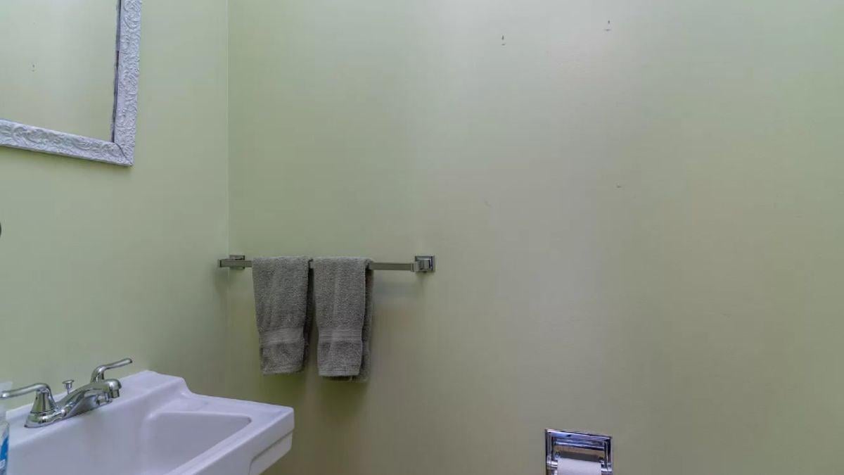 Subtle Bathroom Simplicity with Textured Mirror Frame