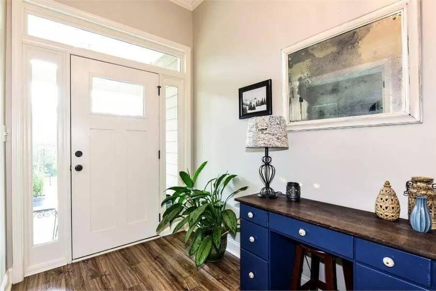 Check Out the Unique Blue Console in This Welcoming Foyer