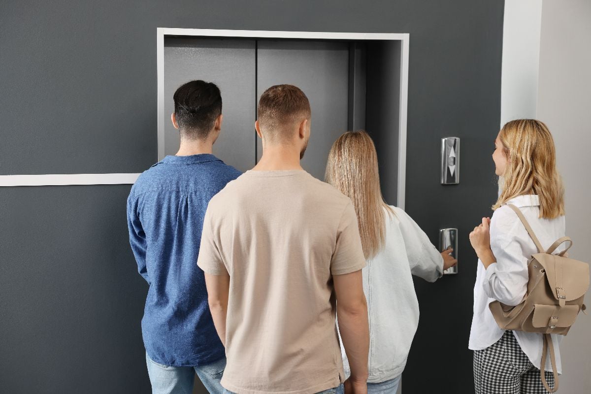 Group of people waiting for elevator.