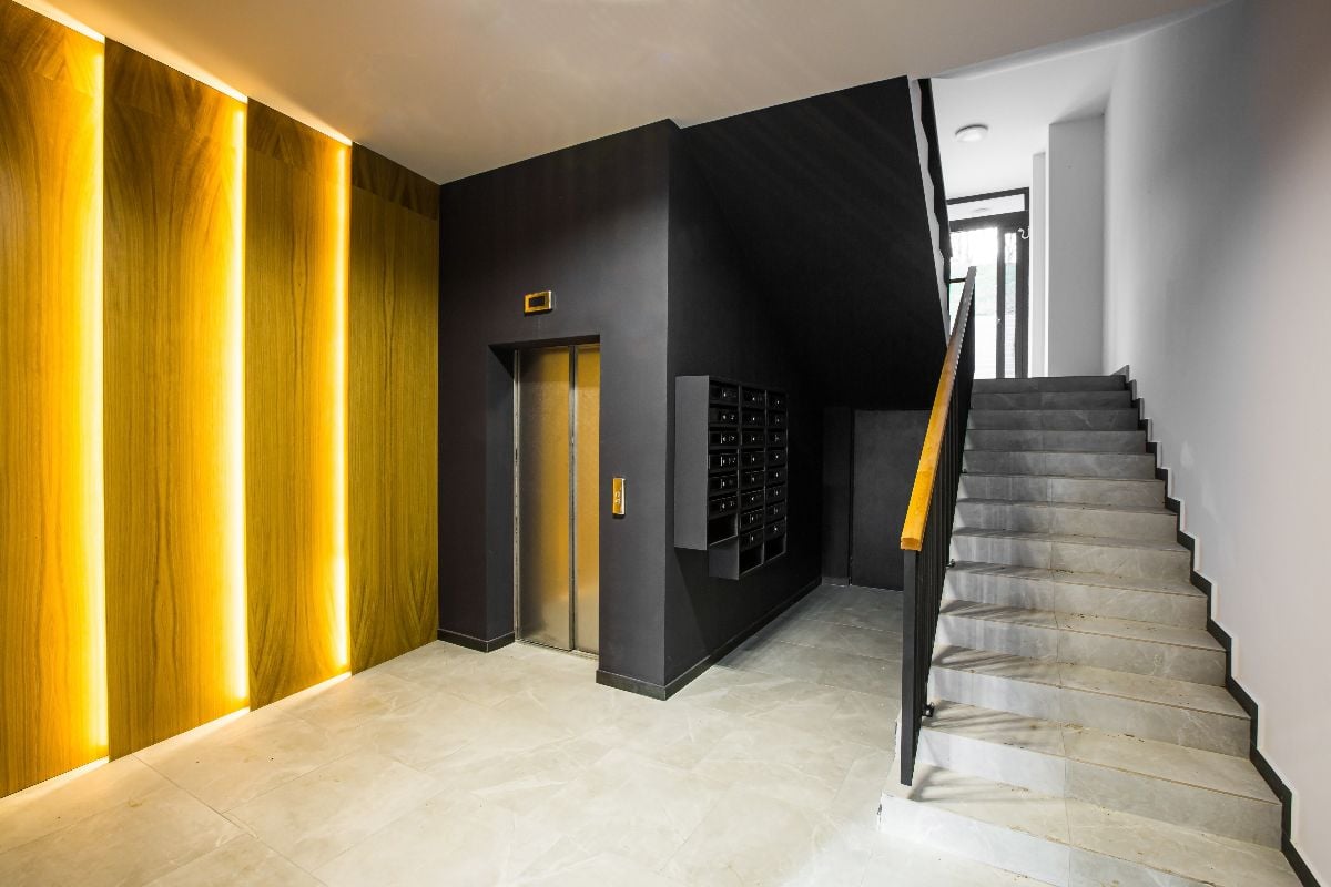 Interior of the corridor hall with elevator and stairs.