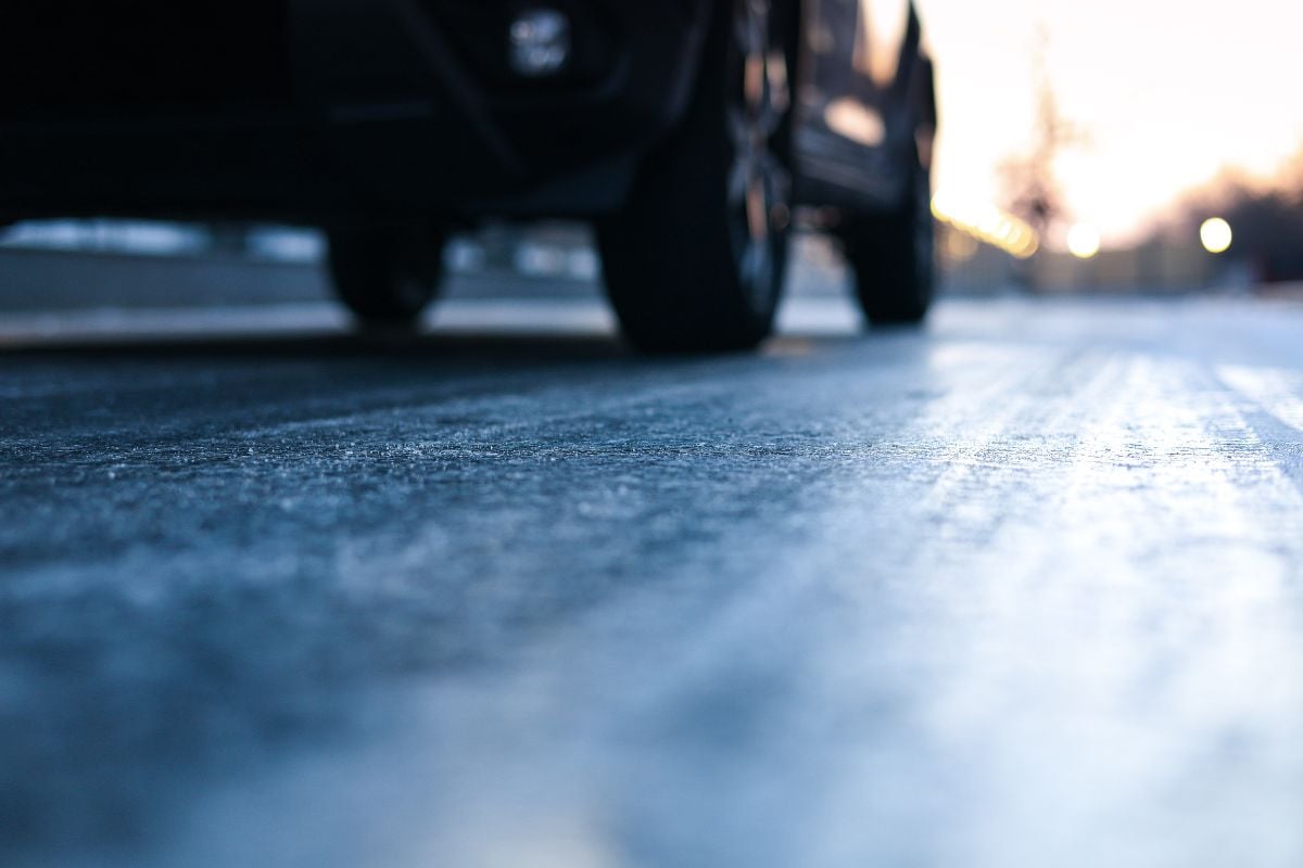 Close up photo of the asphalt covered with ice.