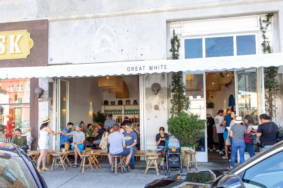A view of patio seating and a long line of customers at Great White.