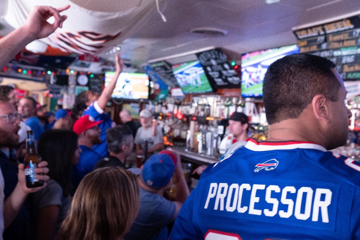Buffalo Bills fans cheer together at Northstar Cafe in San Francisco during a live game broadcast.