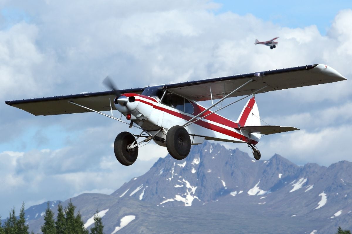 A Super Cub bush plane departs the Lake Hood Gravel Runway.
