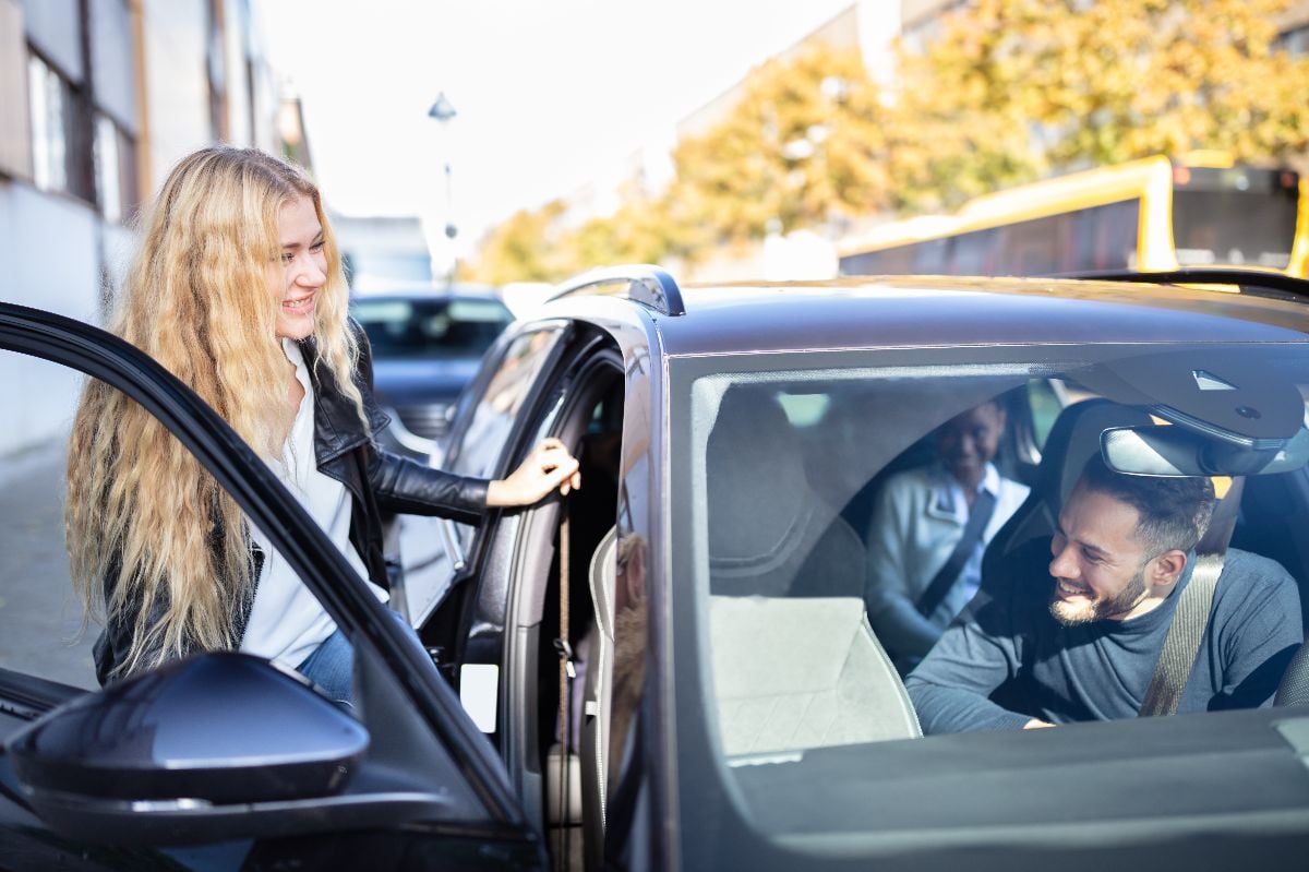 Women sharing ride with friends.