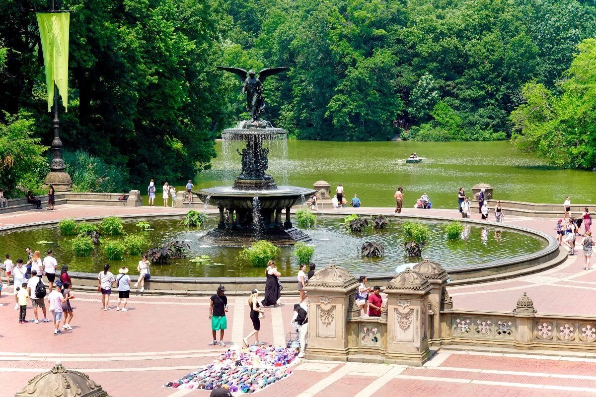 Central Park's iconic Bethesda Fountain and its surrounding lake, boathouse, terrace, sculptures and ornate lower passage.