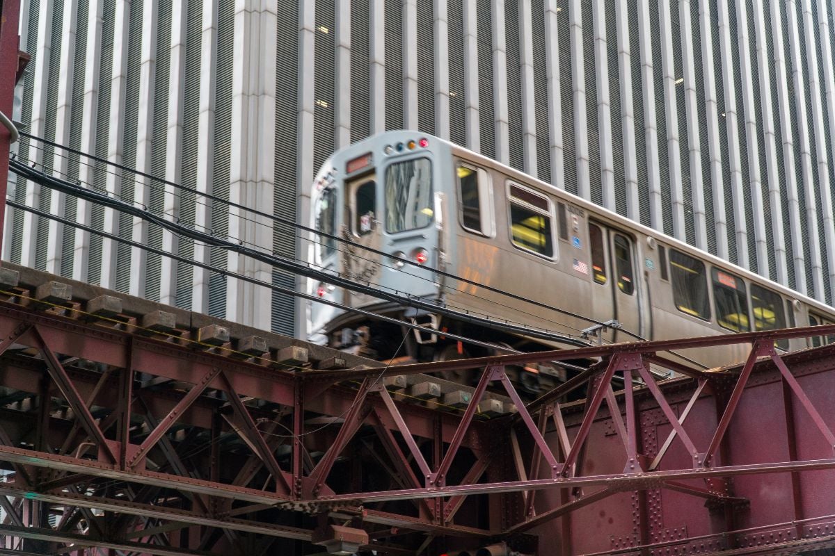 Chicago L train passing by downtown office building.
