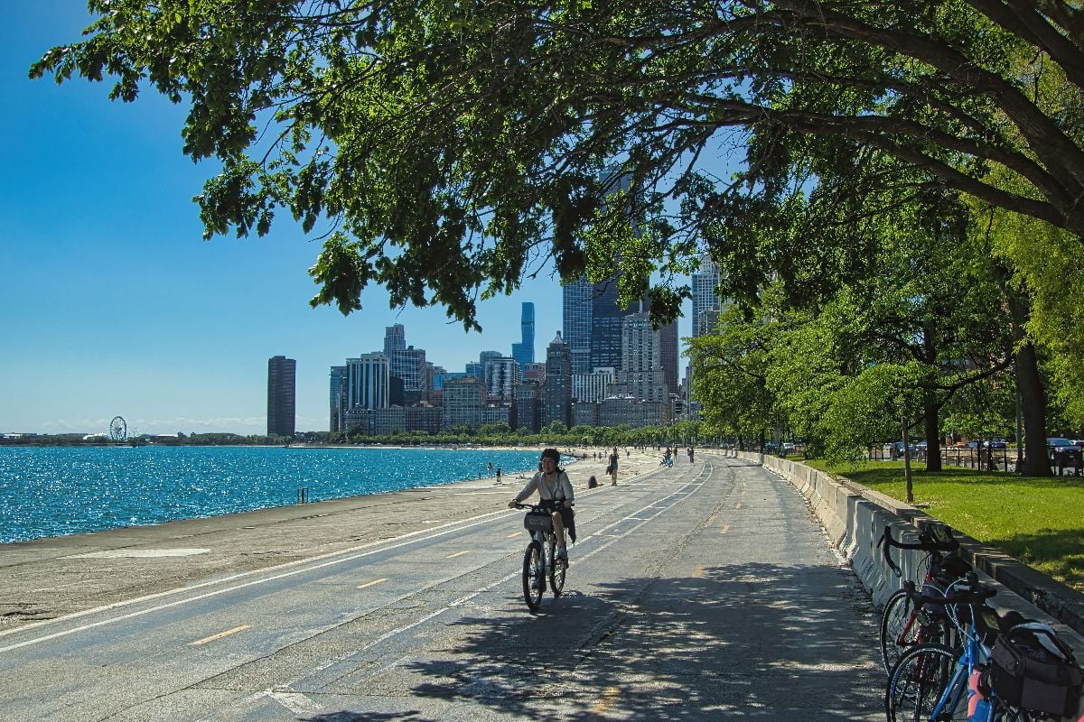A cyclist riding beside Lake Michigan.