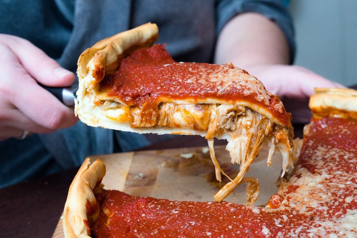 Chicago style deep dish italian cheese pizza with tomato sauce and beef.