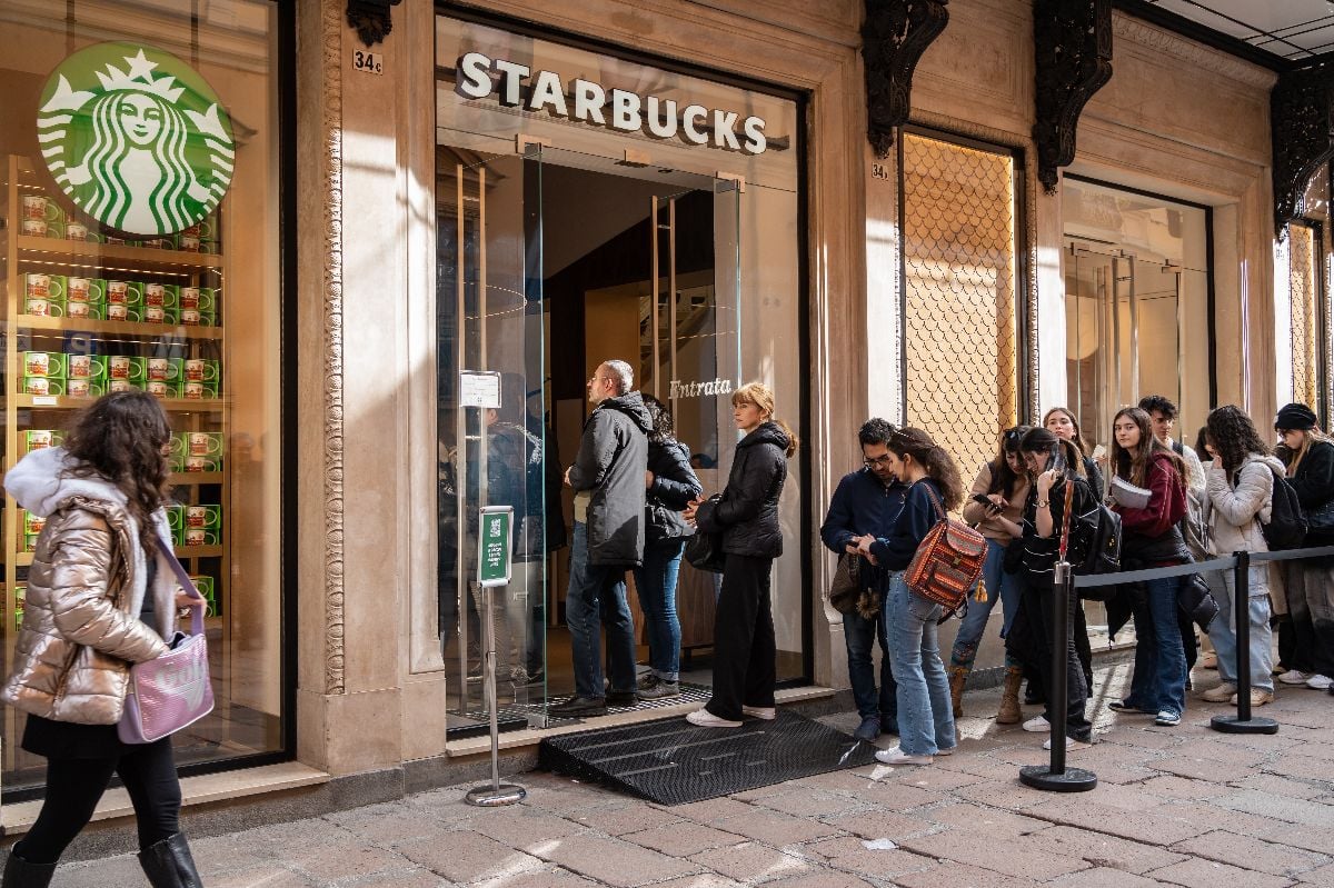 Customers queue in front of Starbucks coffee store.
