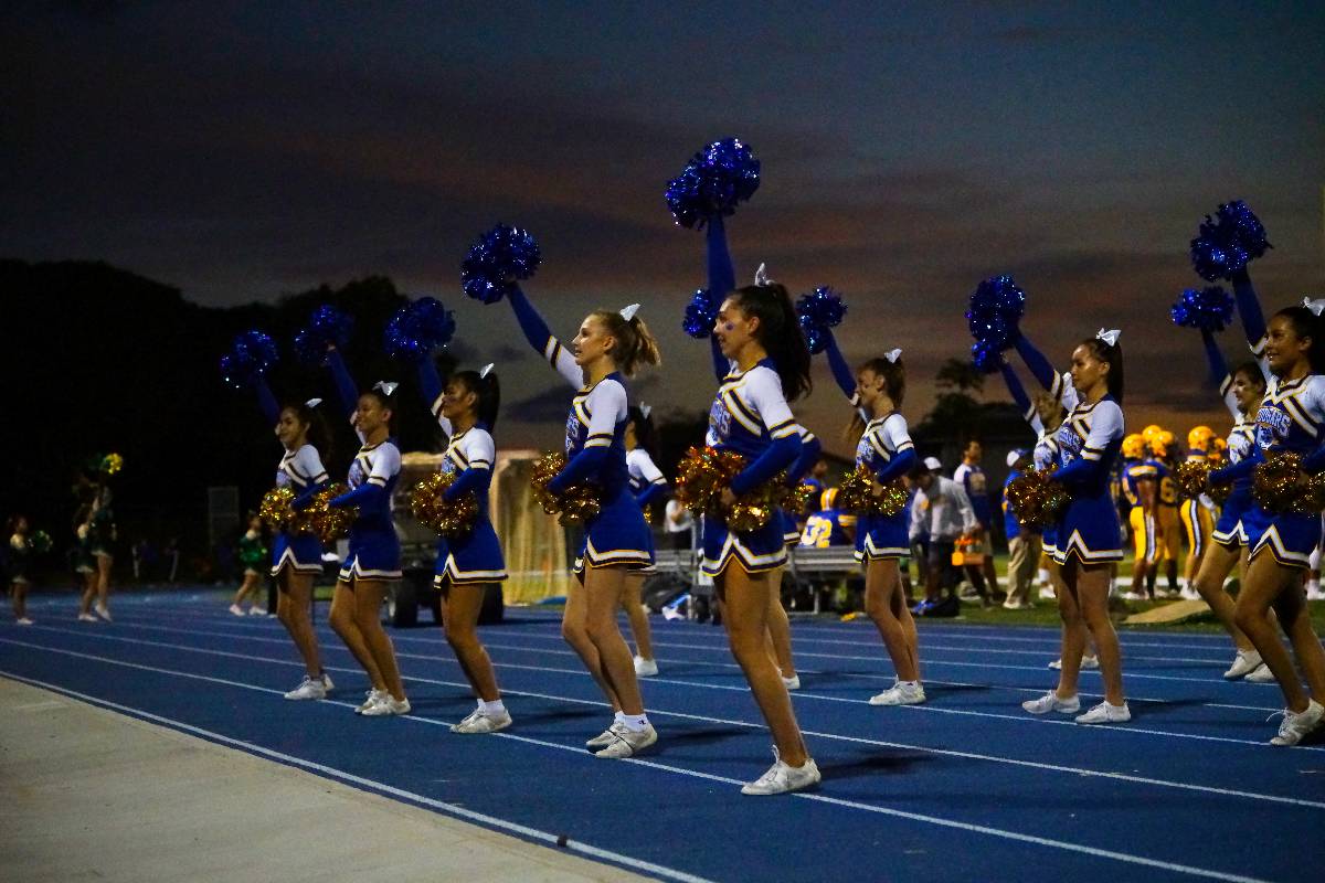 Cheerleaders perform spirited routines.