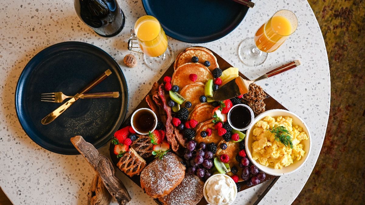 Brunch platter with pastries, pancakes and berries.