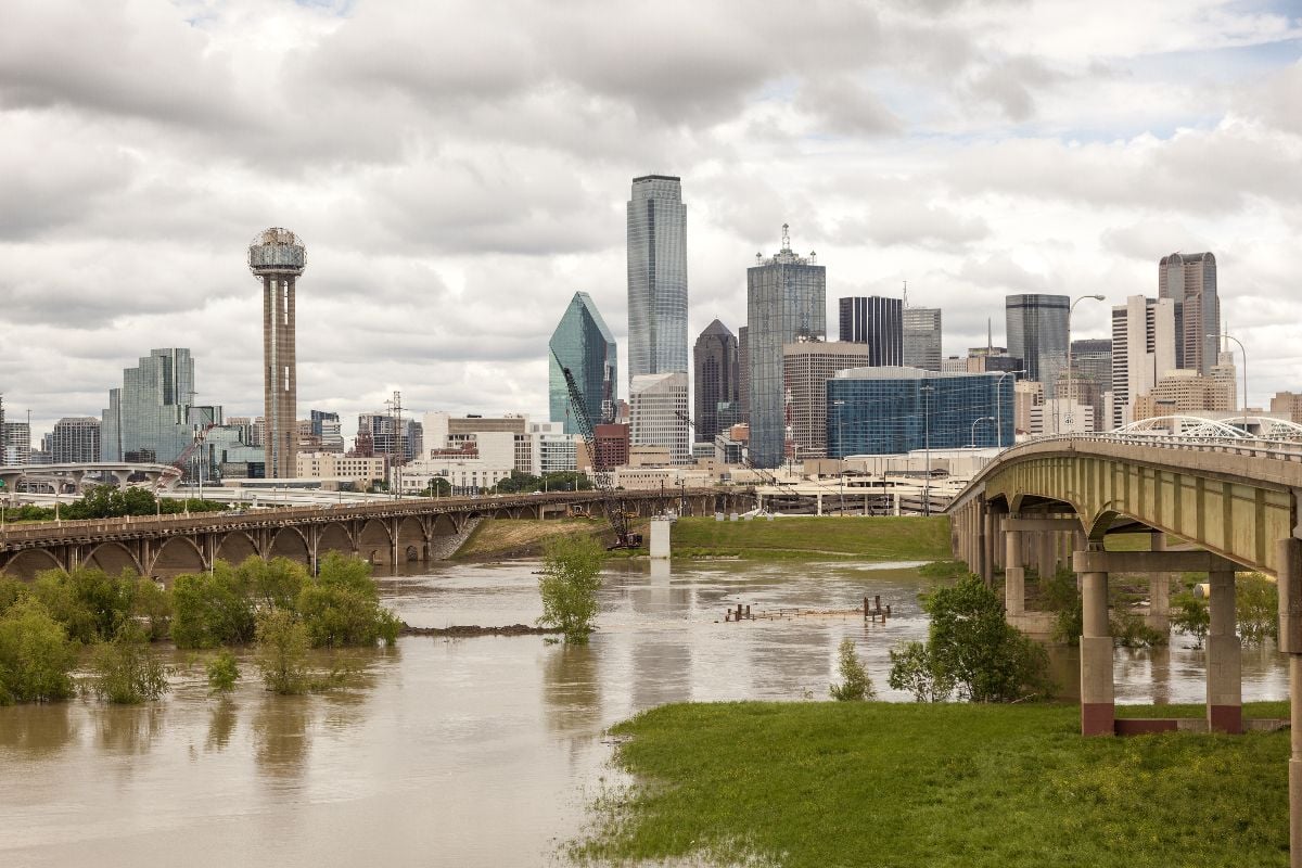 Dallas downtown skyline view with the Trinity River in foreground.