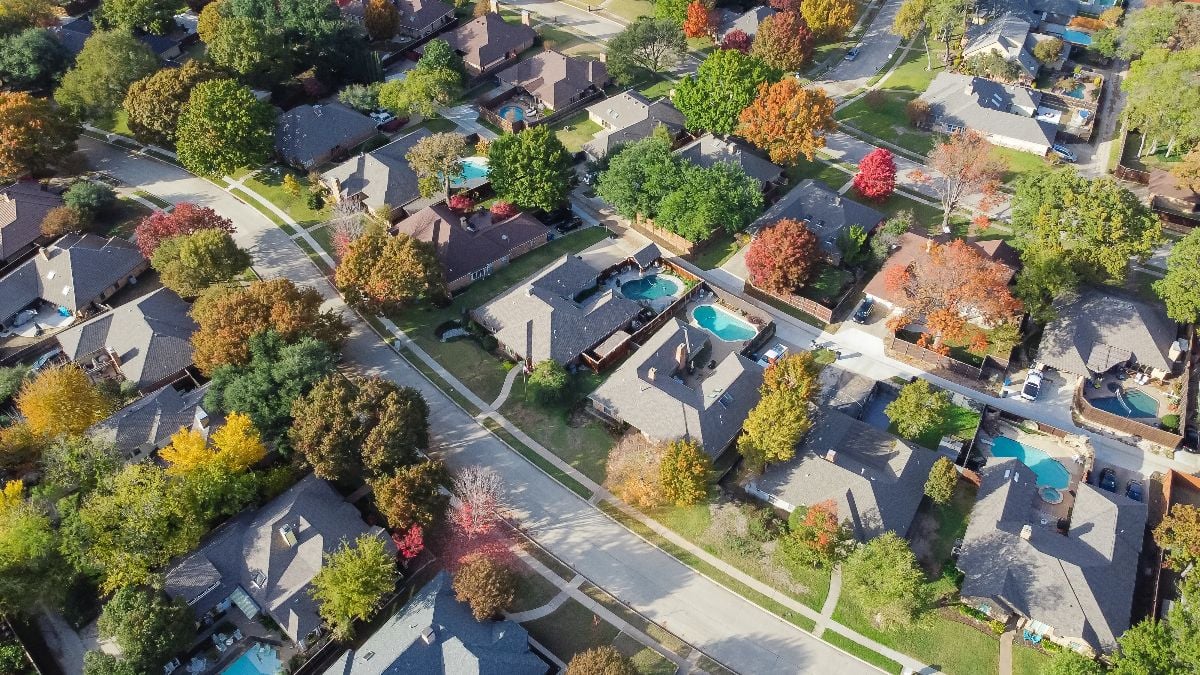 Upscale single family home with swimming pool and colorful fall foliage near Dallas.