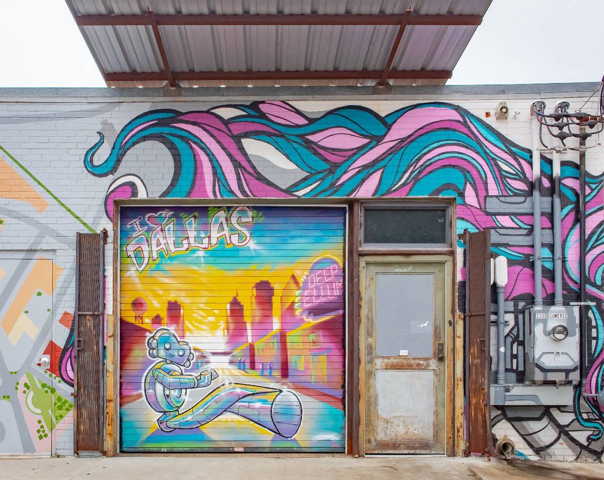 Colorful blue and purple urban artwork on a building at Deep Ellum.