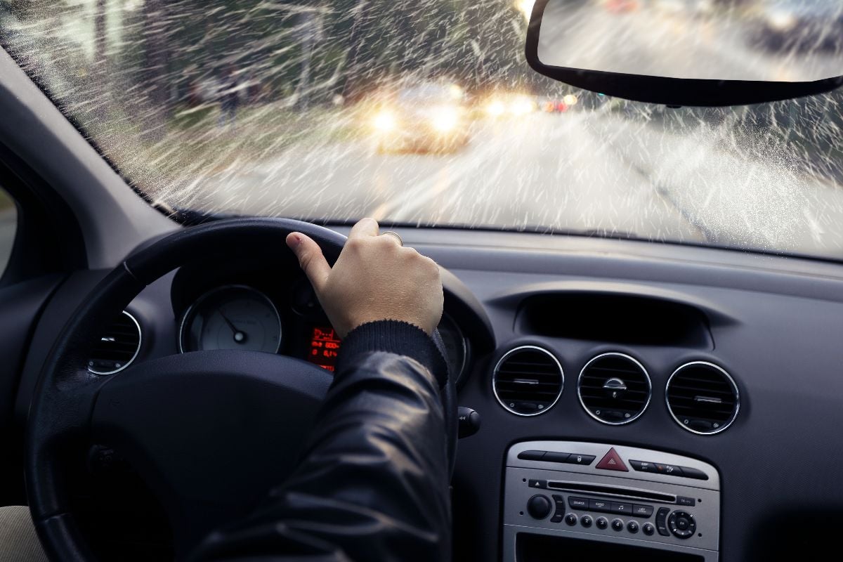 Man driving against snow.