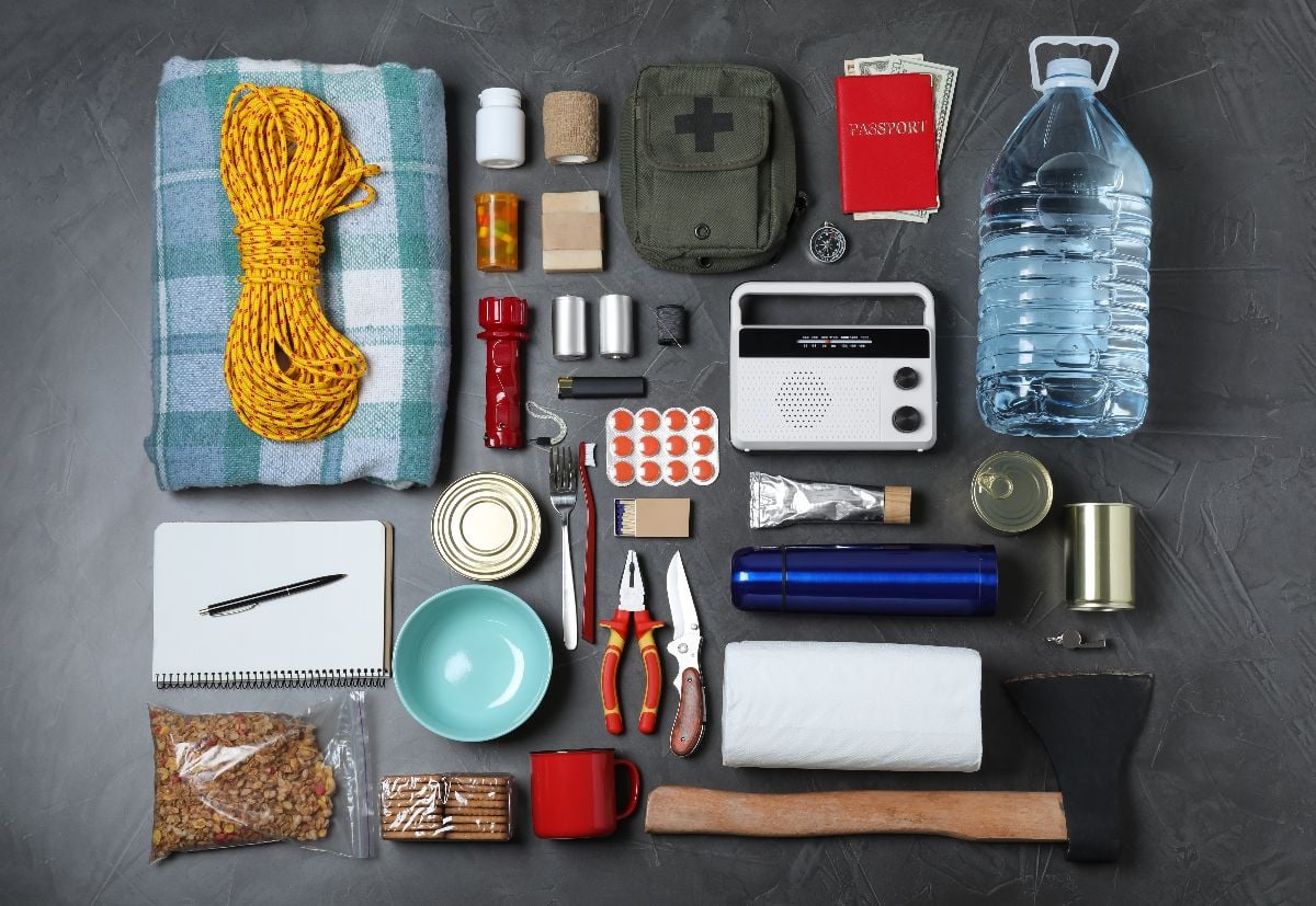 Disaster supply kit for earthquake on dark grey table.