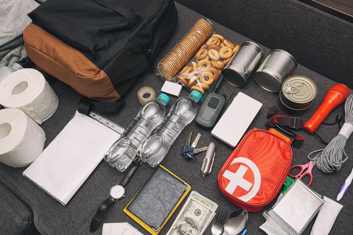 Emergency backpack equipment organized on the table.