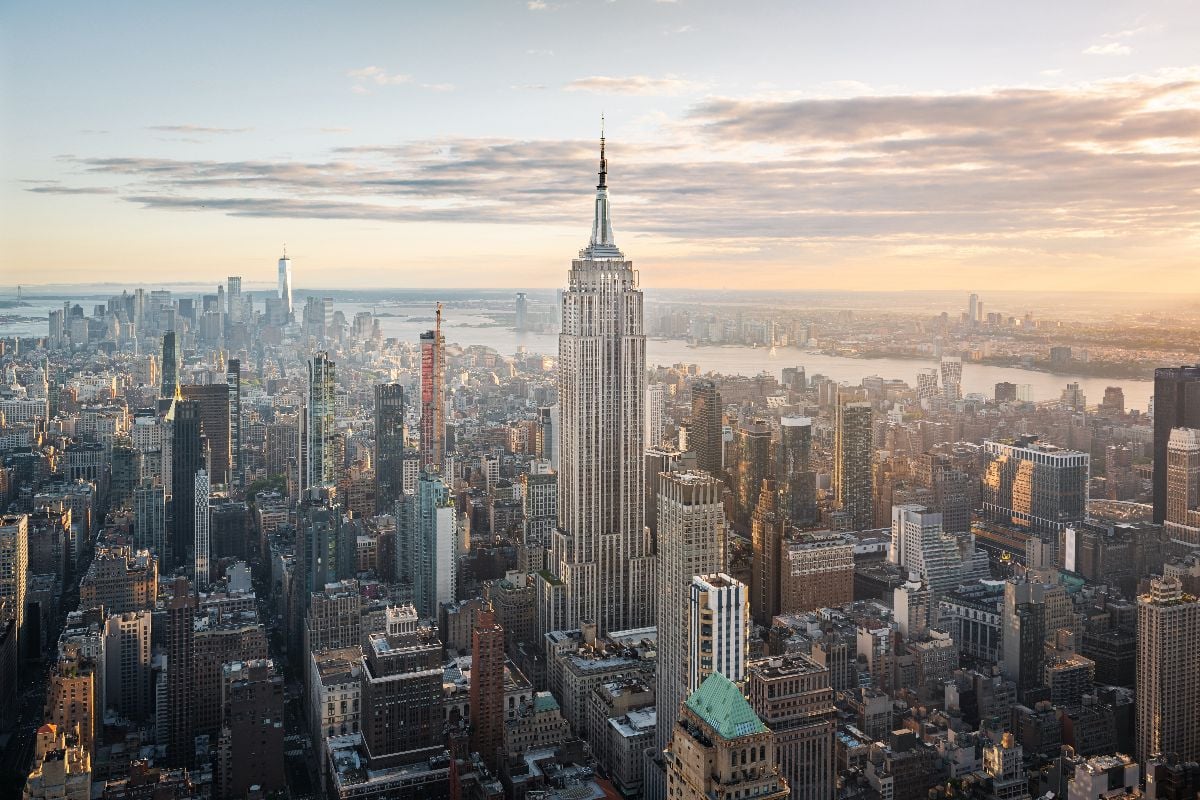 Aerial view of the Empire State Building and downtown Manhattan at dusk.