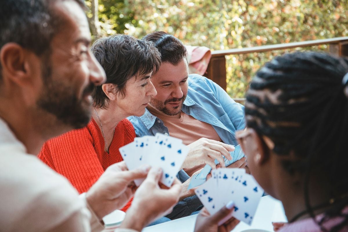 Family playing euchre card game.