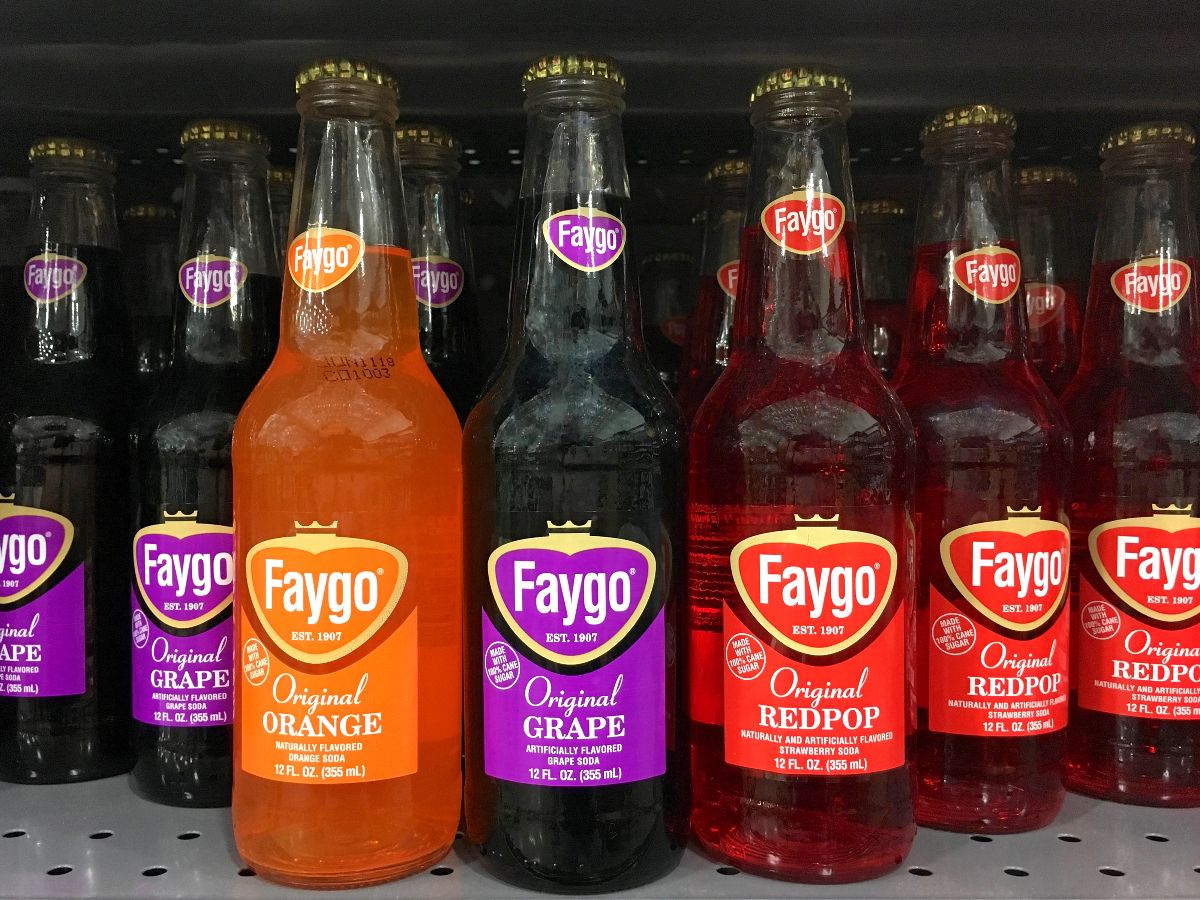Grocery store shelf with bottles of Faygo soda.