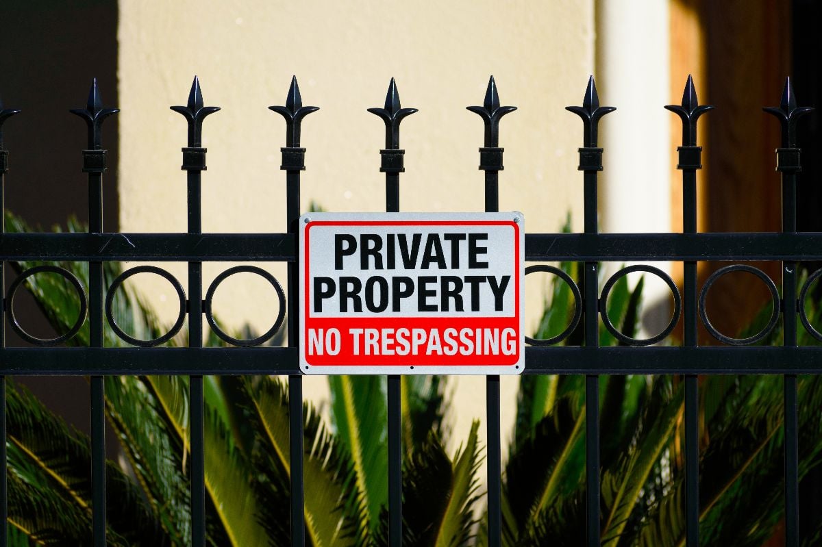 Private Property No Trespassing sign posted on a fence.