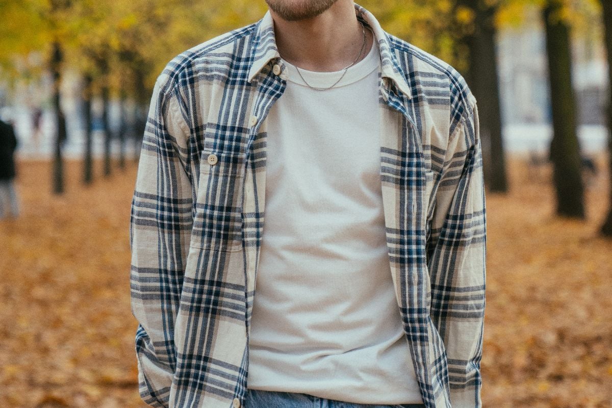 Torso of man wearing flannel in autumn.