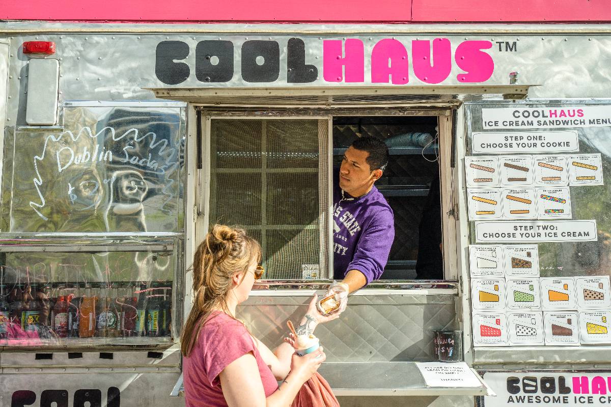 Woman purchase food from food truck.