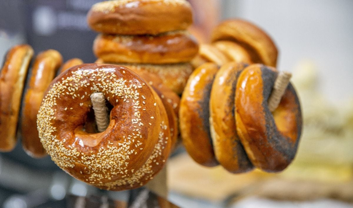 Freshly baked bagels with sesame seeds and poppy seeds closeup.
