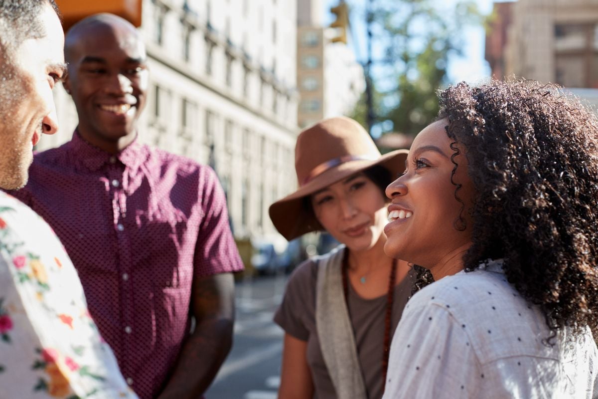 Group of friends meeting on urban street.