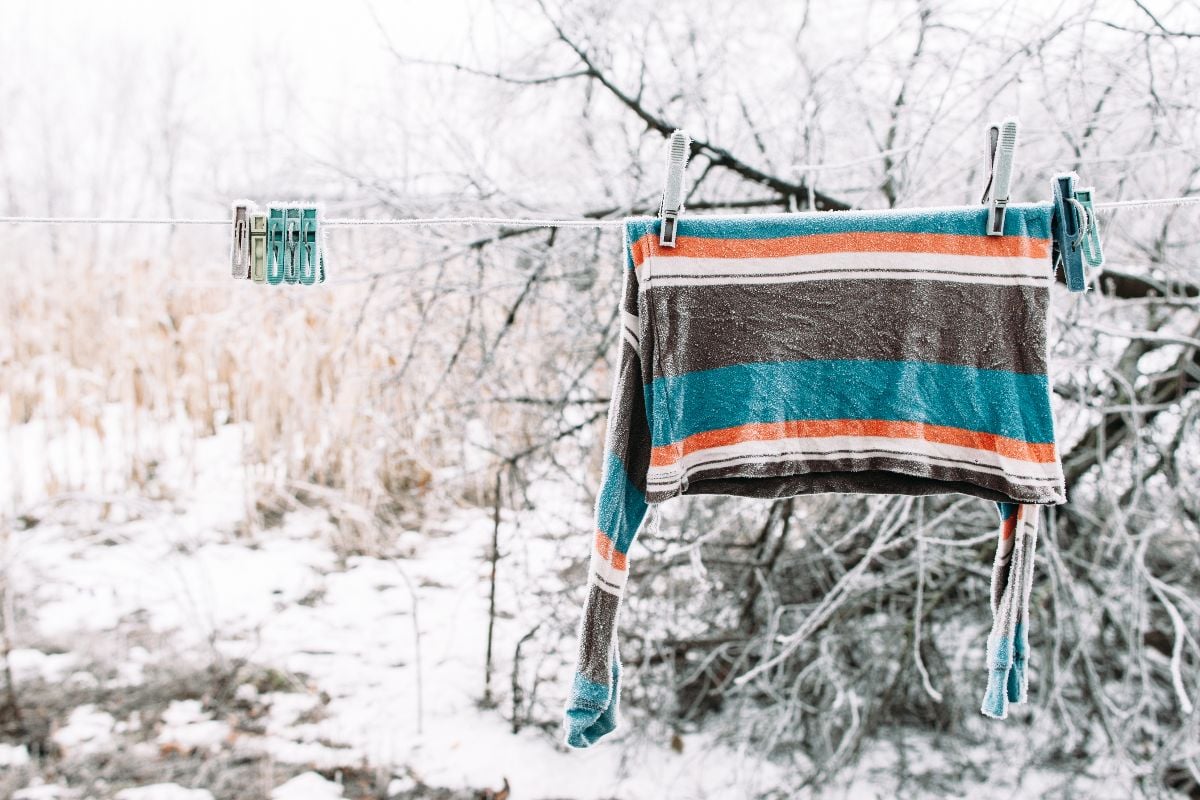 Frozen pullover on clothesline outside. 