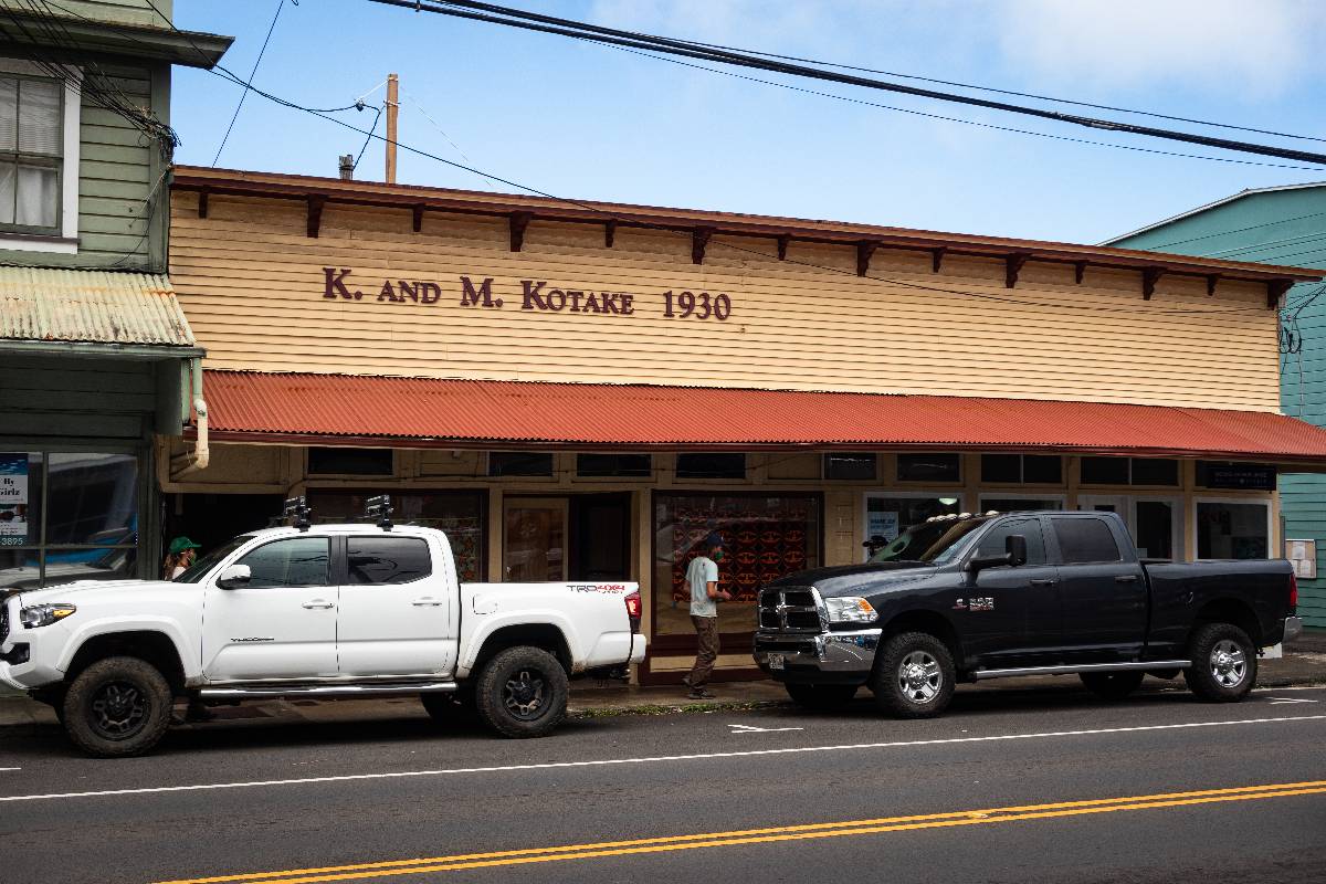 Photo of historic 1930ʻs building with parked trucks.