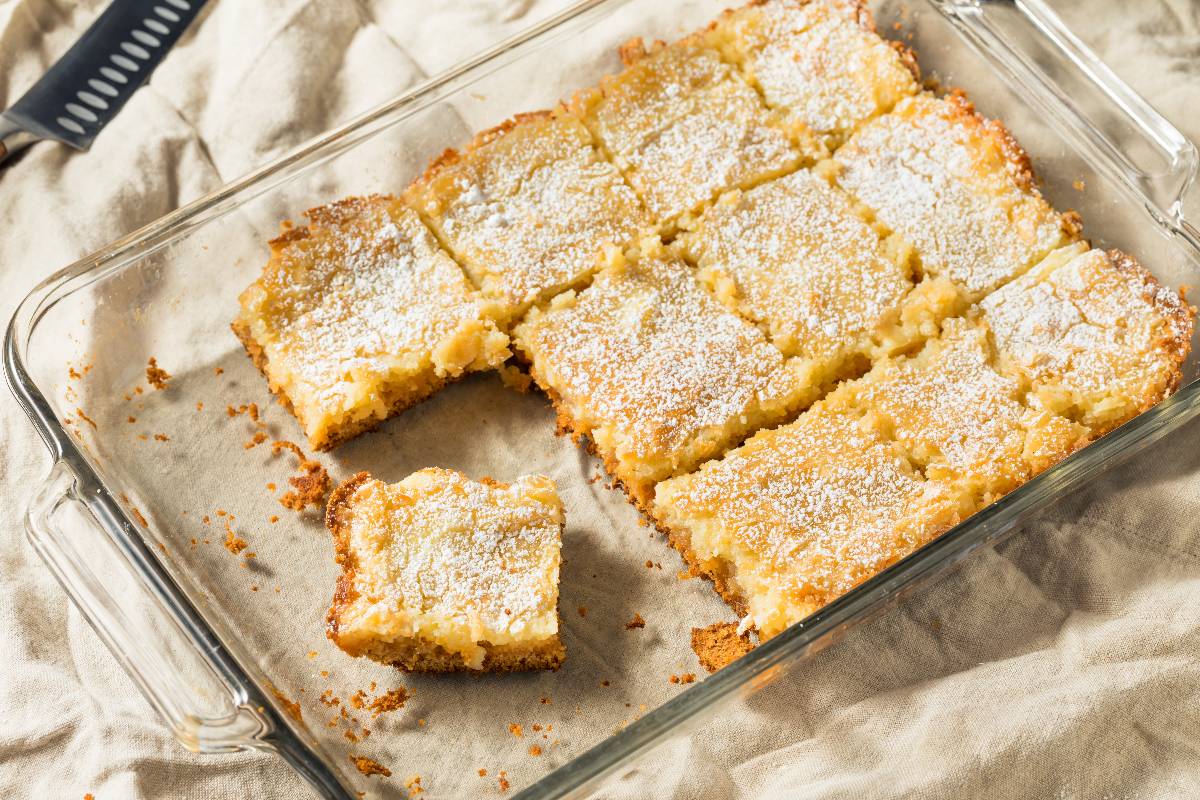 Homemade gooey butter cake with powdered sugar.