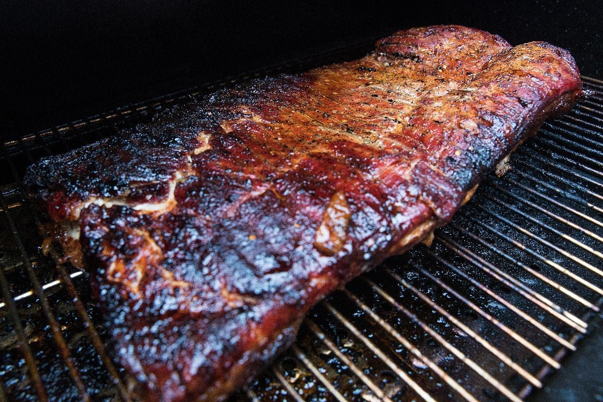 Crispy grilled pork belly on a barbecue.