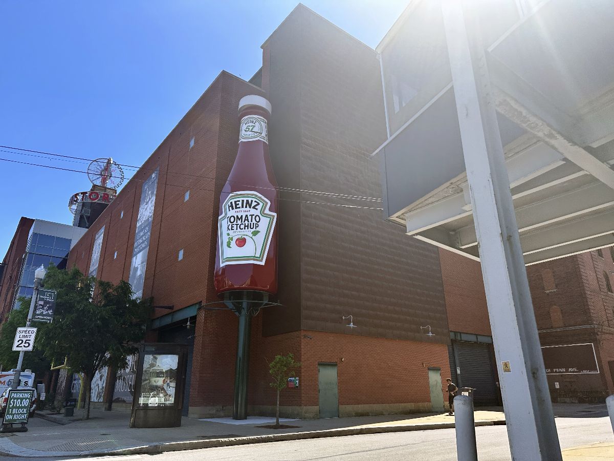 An establishing shot of the Heinz History Center with a large ketchup bottle display.