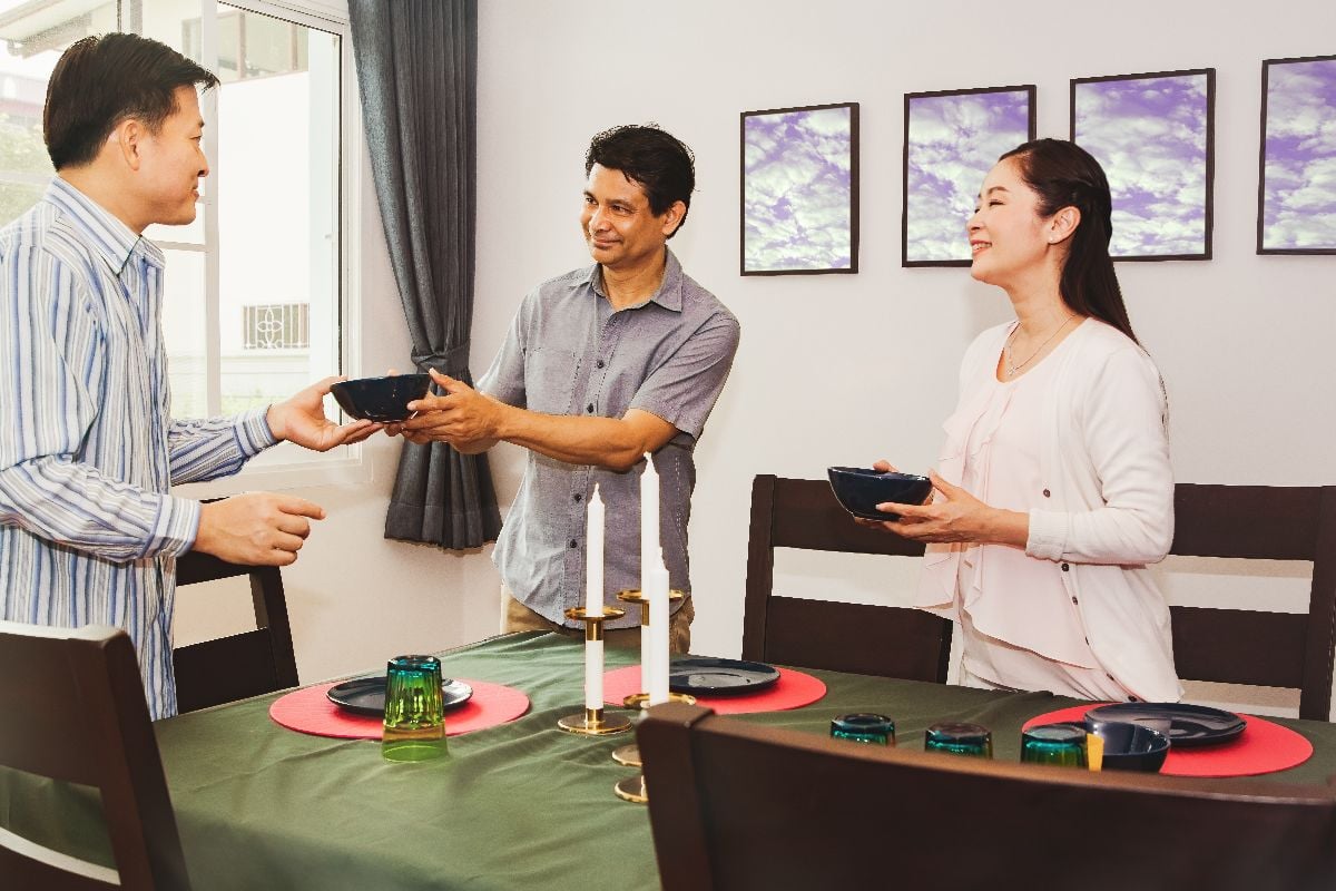 Couple welcoming guest.