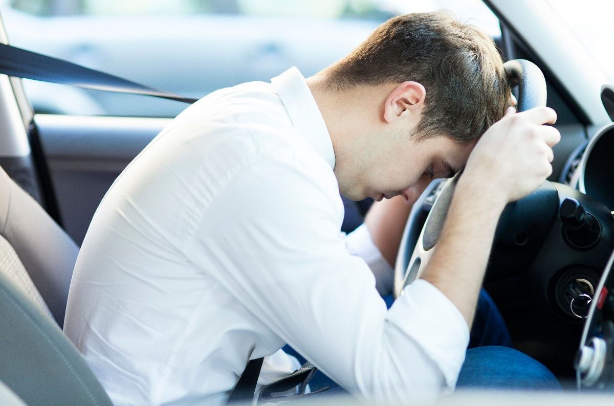Man frustrated inside his car.