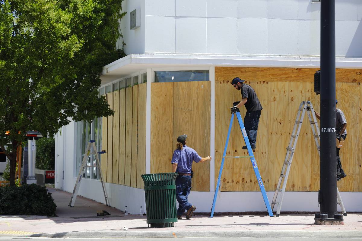 Workers boarding a business in preparation of hurricane.