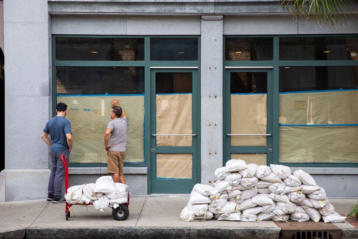 Two workers ready sandbags in preparation of a hurricane.
