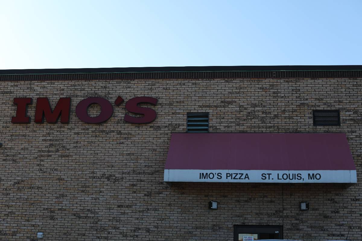 IMO's Pizza logo on a brick wall.