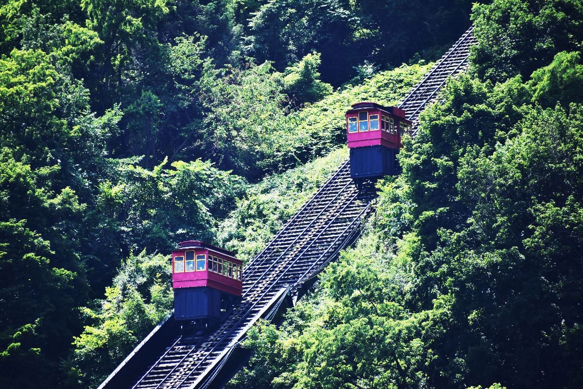 Inclined cars on tracks.