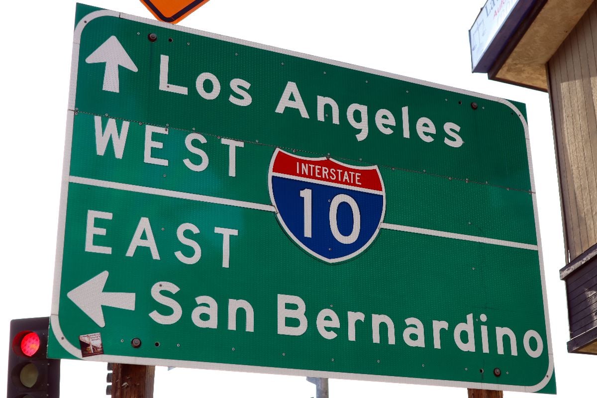 Interstate 10 entrance sign showing west to Los Angeles and east to San Bernardino, California.