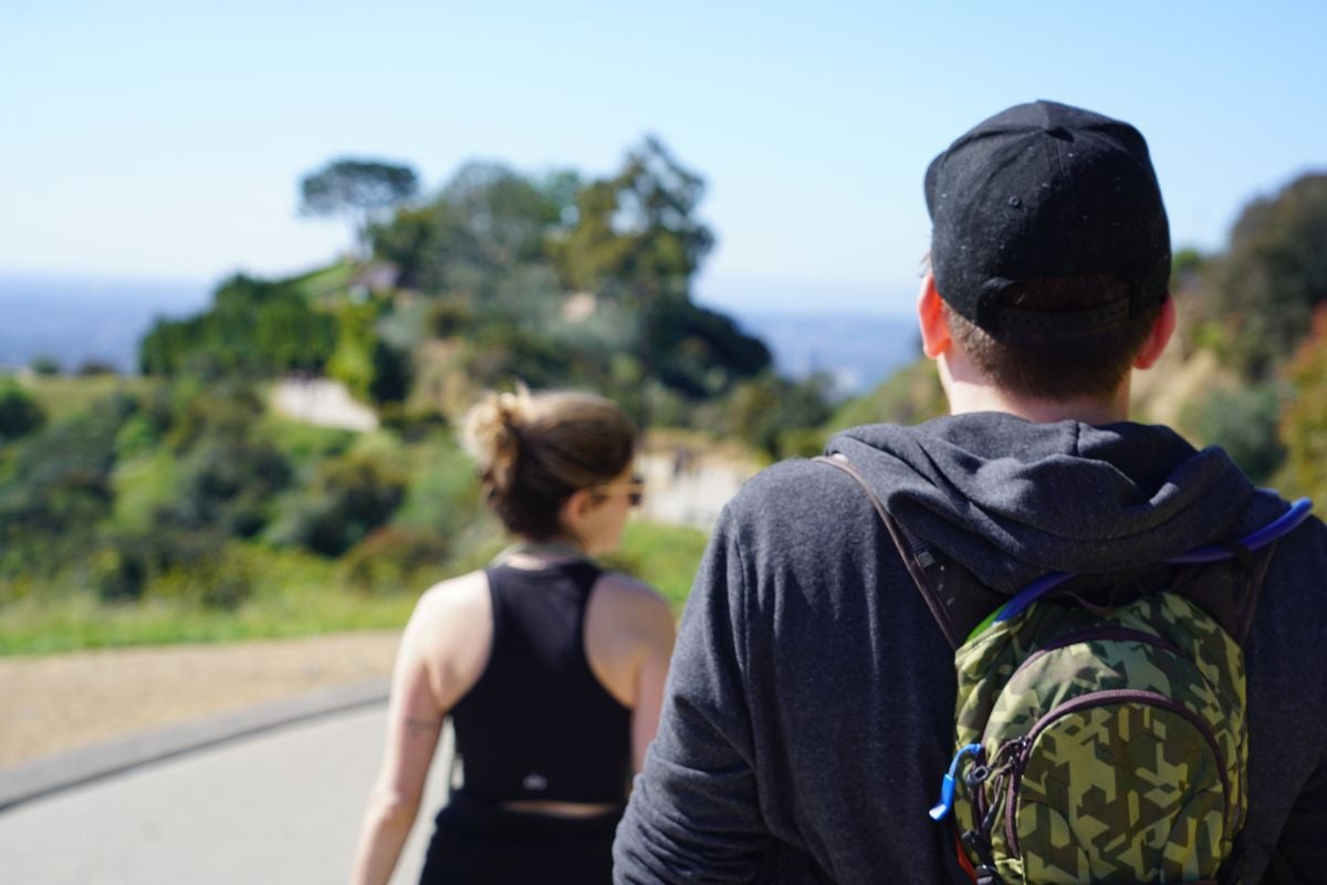 Man and woman walking down path at Runyon canyon park in Los Angeles.