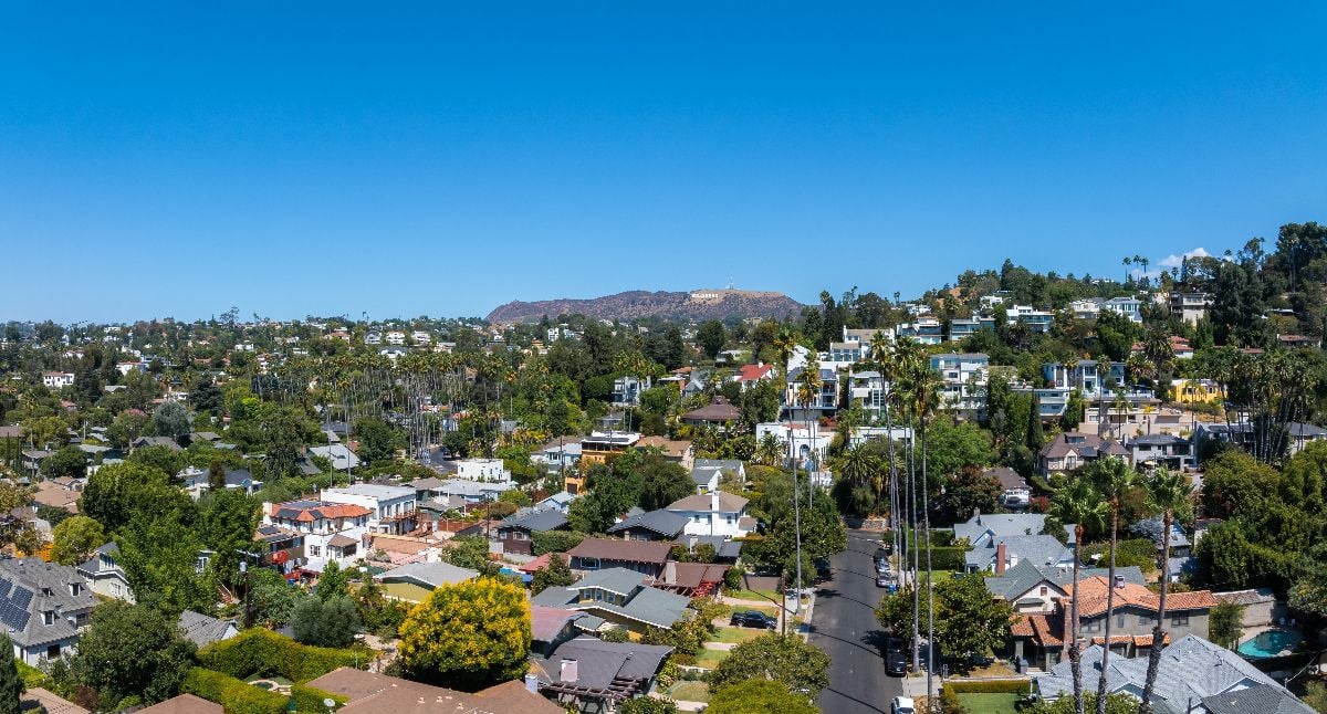 Aerial view of LA neighborhood under a blue sky.