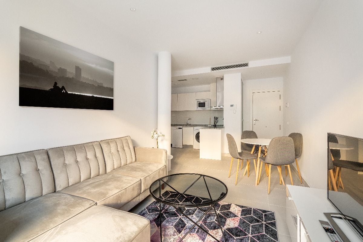 Interior of a studio apartment with white walls.