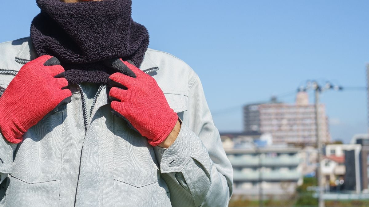 Close-up of a man wearing a neck gaiter.