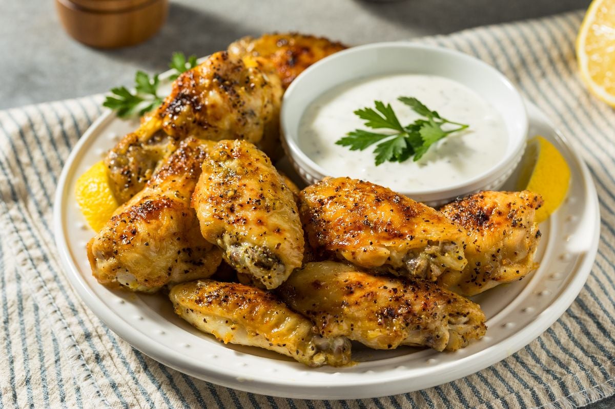 Homemade spicy lemon pepper chicken wings with ranch dressing.