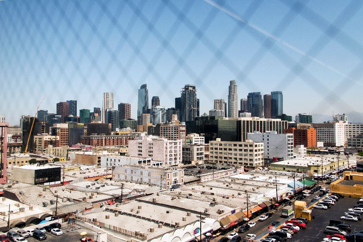 A view of downtown Los Angeles through a wired window.